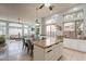 Open kitchen featuring a large island, granite countertops, and seamless flow to the living room at 9678 E Voltaire Dr, Scottsdale, AZ 85260