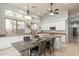 Well-lit kitchen featuring white cabinets, granite countertops, a kitchen island, and a dining area at 9678 E Voltaire Dr, Scottsdale, AZ 85260