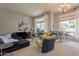 Bright living room featuring plush seating, a modern bar, and large windows with natural light at 9678 E Voltaire Dr, Scottsdale, AZ 85260