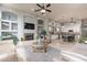 Spacious living room with fireplace, built-ins, tile floors, and an open view to the kitchen at 9678 E Voltaire Dr, Scottsdale, AZ 85260