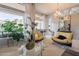 Bright living room featuring plush seating, large windows with natural light, and glass coffee tables at 9678 E Voltaire Dr, Scottsdale, AZ 85260