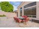 Outdoor patio area featuring travertine tile, a dining table with seating for six, and a view of the backyard at 9678 E Voltaire Dr, Scottsdale, AZ 85260