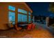 Stylish outdoor patio with dining area, offering views of the home's exterior and landscaping at 9678 E Voltaire Dr, Scottsdale, AZ 85260