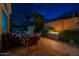 Charming outdoor patio featuring a dining table, fire feature, and view of the pool at 9678 E Voltaire Dr, Scottsdale, AZ 85260