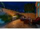 Inviting outdoor patio with comfortable seating, fireplace, and desert landscaping at 9678 E Voltaire Dr, Scottsdale, AZ 85260