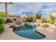 Backyard pool and spa featuring rock features and lush landscaping creating a private and tranquil retreat at 9678 E Voltaire Dr, Scottsdale, AZ 85260
