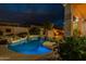 Backyard swimming pool, rocks, tropical plants and patio for outdoor entertaining at 9678 E Voltaire Dr, Scottsdale, AZ 85260