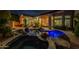 A gorgeous backyard pool area with beautiful palm trees and comfortable seating and landscaping at 9678 E Voltaire Dr, Scottsdale, AZ 85260