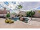 Beautiful backyard pool with rock features, water slide, mature landscaping, and plenty of room to relax and entertain at 9678 E Voltaire Dr, Scottsdale, AZ 85260