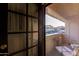 Balcony view through the sliding glass door, featuring outdoor furniture and natural lighting at 10410 N Cave Creek Rd # 2030, Phoenix, AZ 85020