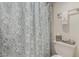 Cozy bathroom featuring a decorative paisley shower curtain and essential storage at 10410 N Cave Creek Rd # 2030, Phoenix, AZ 85020