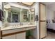 Bathroom vanity featuring a decorative mirror, wood trim, and good storage options at 10410 N Cave Creek Rd # 2030, Phoenix, AZ 85020