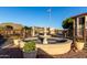 Community fountain with gated entrance and mountain views in the distance at 10410 N Cave Creek Rd # 2030, Phoenix, AZ 85020