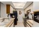 Galley kitchen with modern appliances, tile floors, bright lighting, and plenty of storage at 10410 N Cave Creek Rd # 2030, Phoenix, AZ 85020