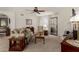 Living room view with neutral tones, ceiling fan, fireplace, and view to kitchen at 10410 N Cave Creek Rd # 2030, Phoenix, AZ 85020