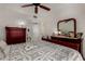 Bedroom has carpet and neutral walls, ceiling fan, and adjoining bathroom with door ajar at 10410 N Cave Creek Rd # 2030, Phoenix, AZ 85020
