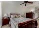 Bedroom features ceiling fan, neutral walls and carpet, and coordinating wood bedroom furniture at 10410 N Cave Creek Rd # 2030, Phoenix, AZ 85020