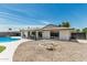 A beautiful backyard featuring a pool, outdoor seating, and rock landscaping at 11215 N 38Th N Ave, Phoenix, AZ 85029