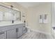 Well-lit bathroom with a double vanity, modern lighting, and a combination shower and tub at 11215 N 38Th N Ave, Phoenix, AZ 85029