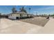 Charming single-story home with white exterior, desert landscaping, and long concrete driveway in a sunny setting at 11215 N 38Th N Ave, Phoenix, AZ 85029
