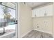Bright laundry room with storage cabinets, tile floors, and access to the backyard at 11215 N 38Th N Ave, Phoenix, AZ 85029