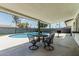 Inviting covered patio with a dining set overlooking the sparkling blue pool and well-maintained backyard at 11215 N 38Th N Ave, Phoenix, AZ 85029