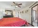 Bedroom features wood-look floors, ceiling fan, and a door leading to the patio at 12222 N Paradise Village S Pkwy # 442, Phoenix, AZ 85032