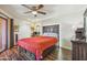 Bedroom with wood floors, ceiling fan, and door to the outside patio at 12222 N Paradise Village S Pkwy # 442, Phoenix, AZ 85032
