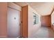 Entryway view of the condo, featuring a modern door and window allowing natural light at 12222 N Paradise Village S Pkwy # 442, Phoenix, AZ 85032