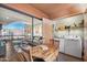 Living and dining space featuring wood floors and laundry machines with view of pool at 12222 N Paradise Village S Pkwy # 442, Phoenix, AZ 85032