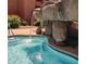 A soothing rock waterfall feature enhances the community swimming pool and the relaxing atmosphere at 12222 N Paradise Village S Pkwy # 442, Phoenix, AZ 85032
