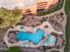Aerial view of a resort-style community pool with lounge chairs, umbrellas, and landscaping at 12222 N Paradise Village S Pkwy # 442, Phoenix, AZ 85032
