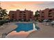 Community pool with lounge chairs and umbrellas, perfect for relaxation and enjoying the sunset views at 12222 N Paradise Village S Pkwy # 442, Phoenix, AZ 85032