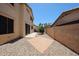 Wide backyard view with brick patio and rock landscaping at 125 N 22 Pl # 14, Mesa, AZ 85213