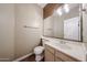 Stylish powder room includes an elongated mirror and wood-look tile flooring at 125 N 22 Pl # 14, Mesa, AZ 85213