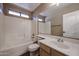 Bright bathroom featuring a shower-tub combo and a single sink vanity at 125 N 22 Pl # 14, Mesa, AZ 85213