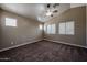 Bright bedroom with neutral walls, plush carpet, and a modern ceiling fan at 125 N 22 Pl # 14, Mesa, AZ 85213