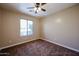 Bright bedroom features a ceiling fan, neutral walls and plush brown carpet at 125 N 22 Pl # 14, Mesa, AZ 85213
