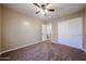 Bedroom with carpet, neutral walls, ceiling fan, closet with sliding doors, and an ensuite at 125 N 22 Pl # 14, Mesa, AZ 85213