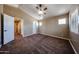 Bedroom with carpet, neutral walls, ceiling fan, and natural light from three windows at 125 N 22 Pl # 14, Mesa, AZ 85213