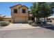 Two-story home featuring a two-car garage and low maintenance desert landscaping in front at 125 N 22 Pl # 14, Mesa, AZ 85213