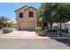 Charming two-story home featuring a two-car garage, desert landscaping, and mature trees at 125 N 22 Pl # 14, Mesa, AZ 85213