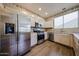 Open kitchen featuring stainless appliances, wood-look tile, and natural cabinets at 125 N 22 Pl # 14, Mesa, AZ 85213