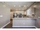 Spacious kitchen featuring stainless appliances, an island, and neutral cabinets at 125 N 22 Pl # 14, Mesa, AZ 85213