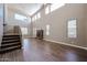 Open living room with a fireplace, tile flooring, and stairs at 125 N 22 Pl # 14, Mesa, AZ 85213