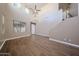 Open living room with large windows, a ceiling fan, and tile flooring at 125 N 22 Pl # 14, Mesa, AZ 85213