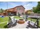 Beautiful backyard featuring a pool, fire pit, patio and artificial turf for easy maintenance at 13709 W Rovey Ave, Litchfield Park, AZ 85340