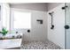 Bright bathroom features textured subway tile and modern fixtures in shower and tub at 13709 W Rovey Ave, Litchfield Park, AZ 85340