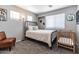 Bedroom with multiple windows, dark metal bed, and a small crib at 13709 W Rovey Ave, Litchfield Park, AZ 85340