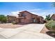 Attractive two-story home featuring a spacious driveway and desert landscaping at 13709 W Rovey Ave, Litchfield Park, AZ 85340